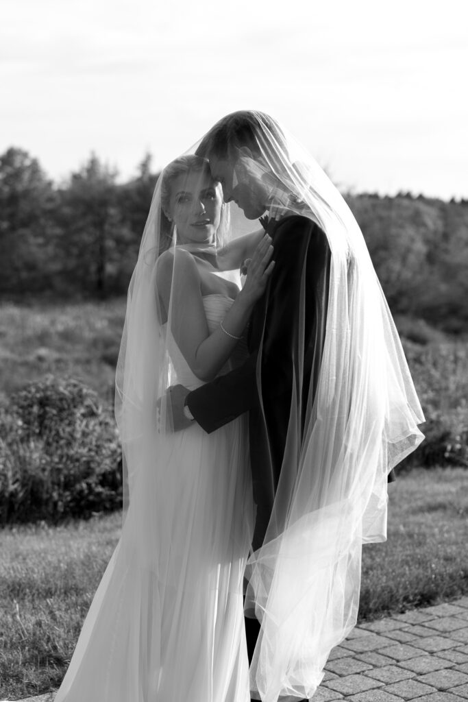 Vermont Wedding Photographer | Couple Embracing under a veil on their wedding day | Documentary Style Editorial Wedding Photos