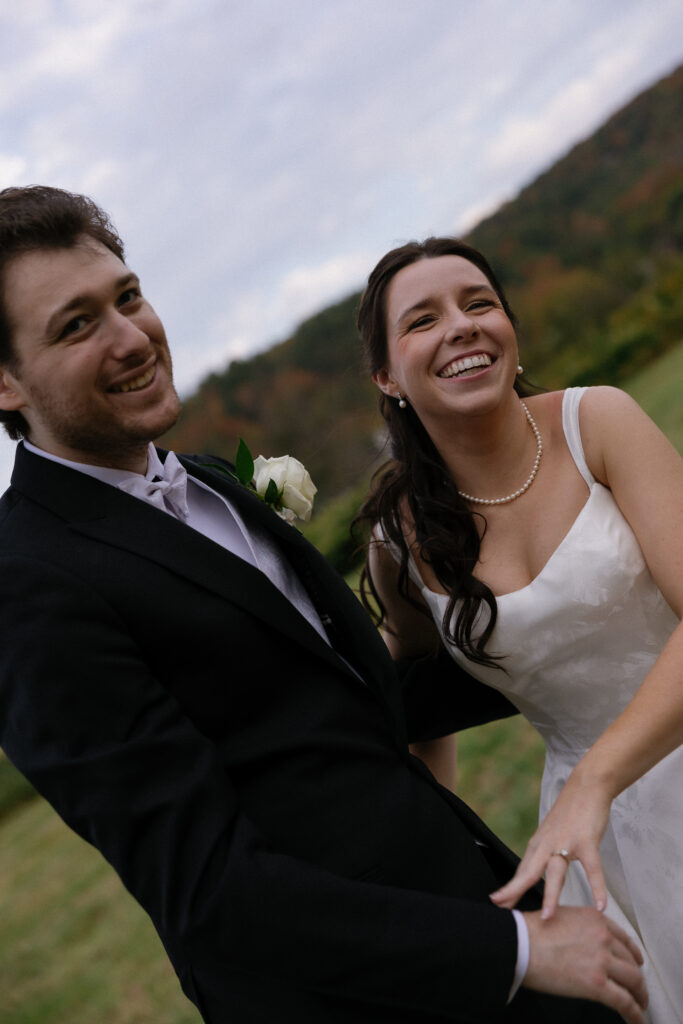 Wedding Photographers in Vermont | Sincerely Liz Photography Documentary and Editorial Wedding Photography | A joyful couple on their wedding day, holding hands and smiling widely.