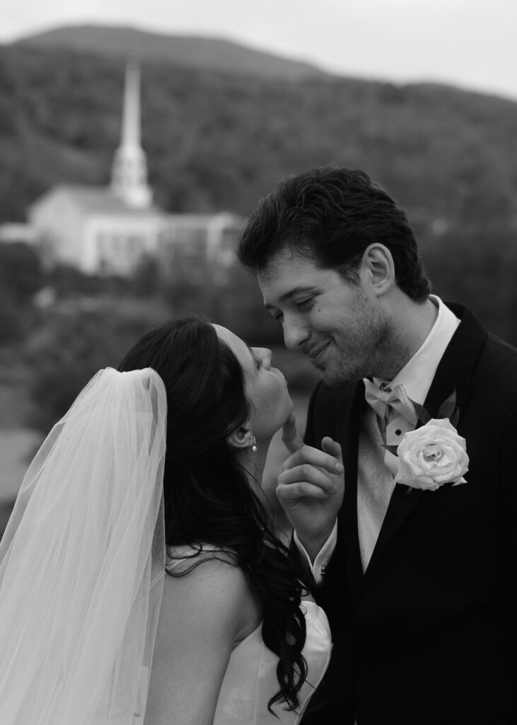 Wedding Photographer VT | Sincerely Liz Photography Documentary and Editorial Wedding Photography | A bride and groom share a tender moment, smiling at each other. The bride wears a veil and the groom has a rose boutonniere.