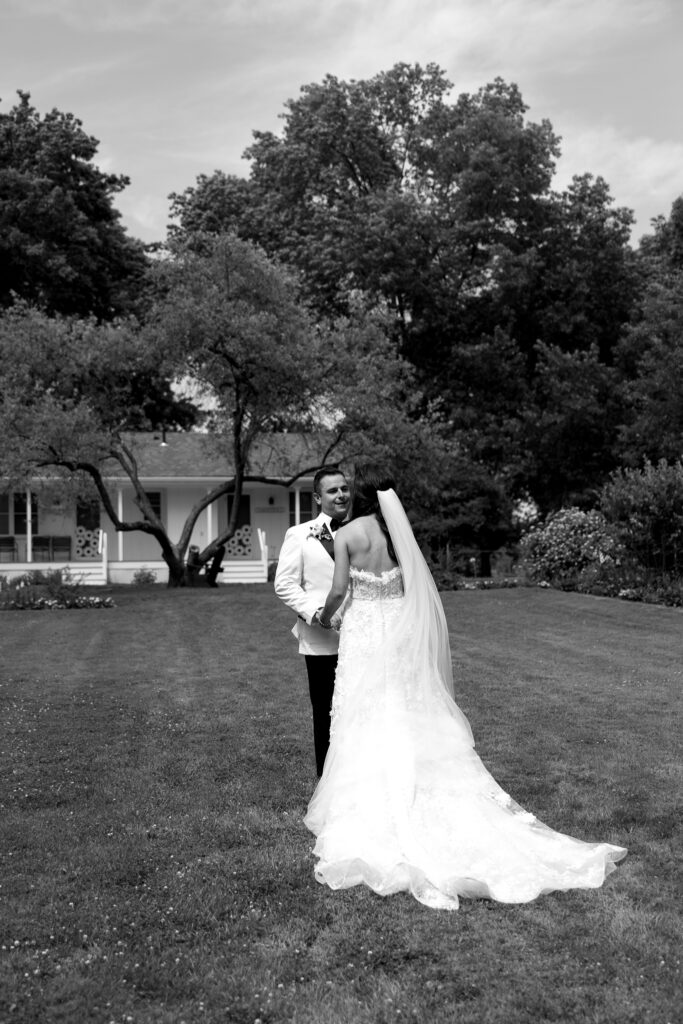 Bride and groom sharing a quiet moment on the lawn during their Basin Harbor wedding in Vermont