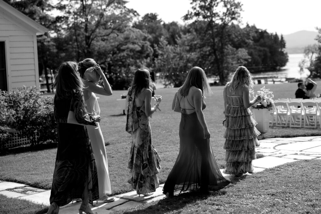 Wedding guests enjoying the open lawns and tree-lined grounds at Basin Harbor