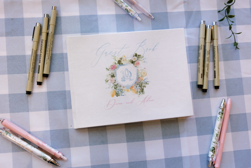 Floral wedding stationery with a pale blue monogram and soft pink accents for a Basin Harbor celebration