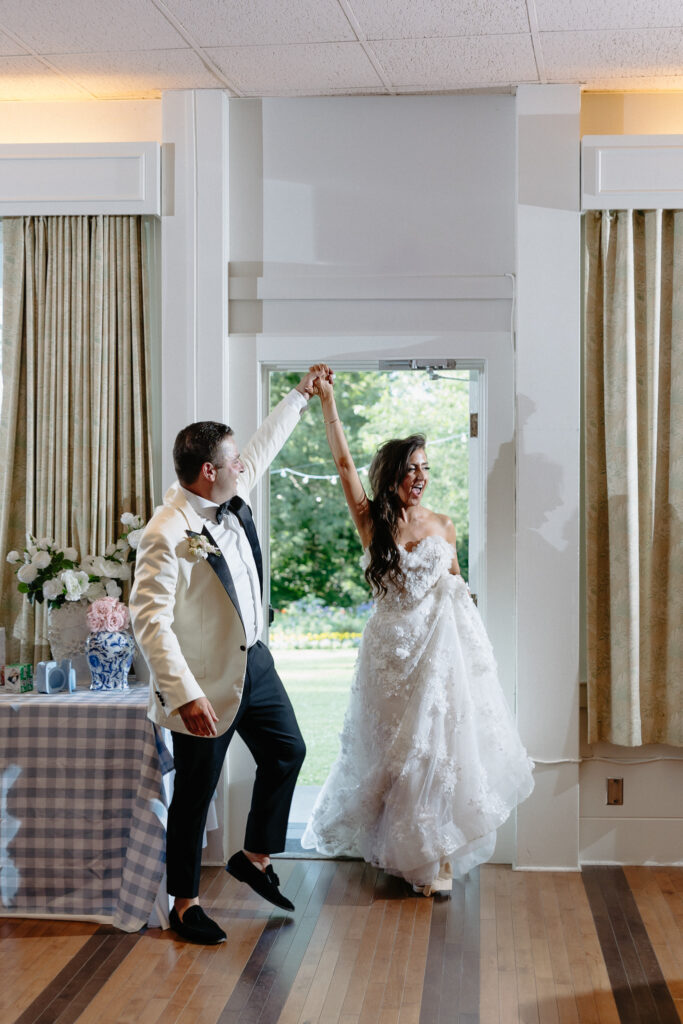 Newlyweds dancing together inside a bright reception space at Basin Harbor